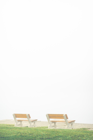 empty bench on misty lakeの写真素材