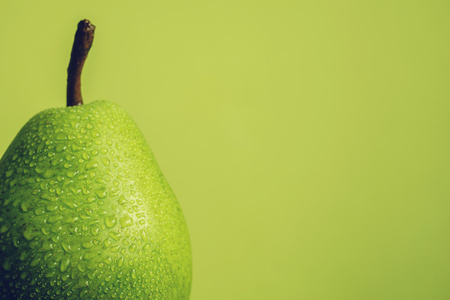 Close up of grean pear with drops of waterの写真素材