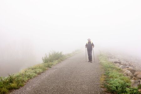 tourist on a trip in the autumn mistの写真素材