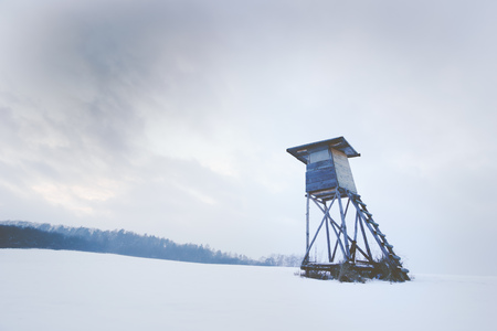 Winter wooden hunting high hide in a snowy white landscapeの写真素材