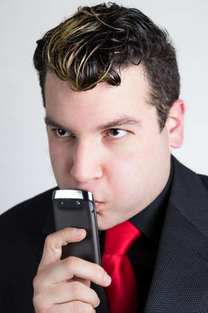 Thoughtful businessman with phoneの写真素材