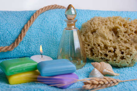 composition of toiletries, shells, soaps, sponges with candleの写真素材