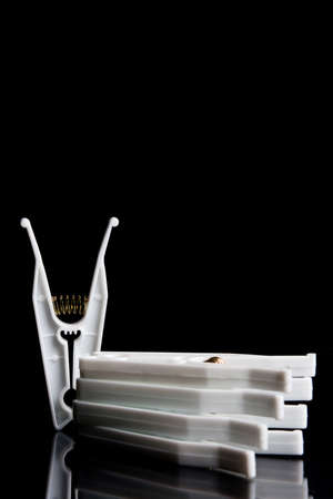 composition with four clothespins on a black backgroundの写真素材