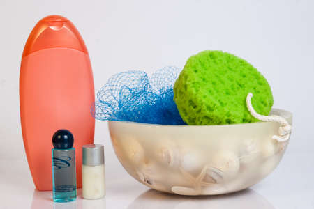 soaps, shampoos and sponges on white background