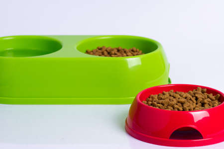 bowls of dry food and water for catsの写真素材