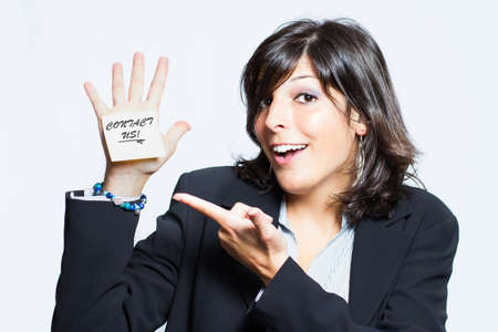 beautiful brunette secretary indicates card saying  contact us の写真素材