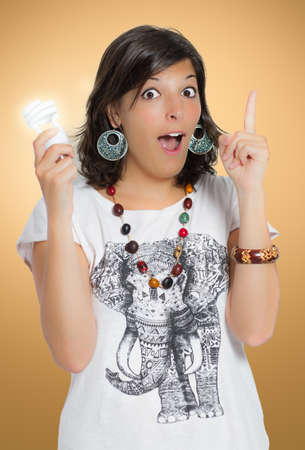 young woman holding a energy saving bulb and has an idea  concept of innovationの写真素材