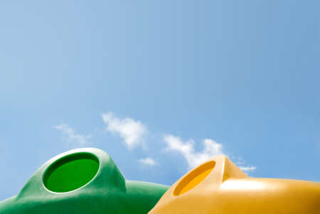 waste containers against a serene blue skyの写真素材