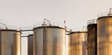 large tanks for petrol and oil at the sunsetの写真素材