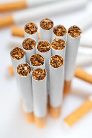 cigarettes disposed dirorderly over white background