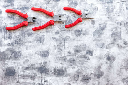 Set of red pliers on a gray background. Work tools.の写真素材
