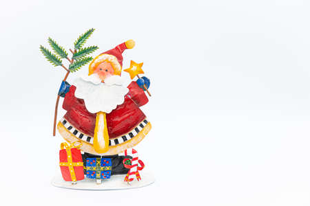 Handmade Santa Claus figure made of tin with gifts placed at his feet with planty of copy space on the right.の写真素材