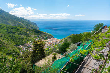 The village of Minori nestled in green hills seen from the Amalfi Coast road.