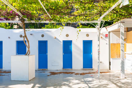 Positano, Italy. May 27th, 2020. Beach changing rooms with blue doors and white wall.の写真素材