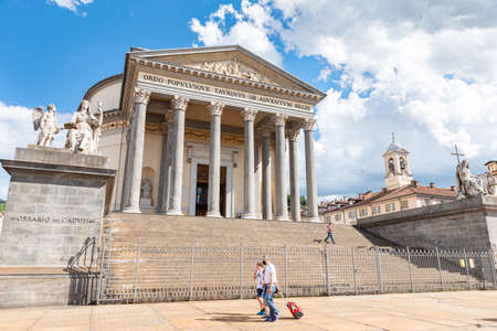 Turin, Italy. May 12, 2021. View of the Church of the Great Mother of God with some person passing by carrying a baggage.のeditorial素材
