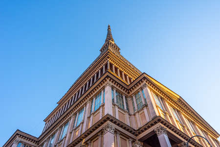 Turin, Italy. December 13th, 2020. Bottom-up view of the tower of the Mole building in Turin against a clear blue sky.のeditorial素材