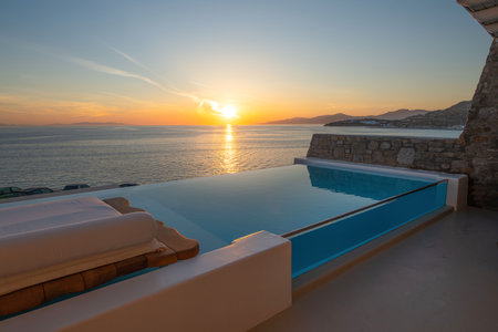 Swimming pool at sunset. Greece, Santorini island.の写真素材