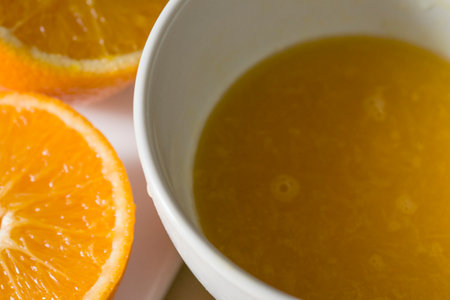 orange juice and orange fruits on the tableの写真素材