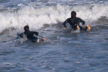 Surfers in action on a sunny day.の写真素材