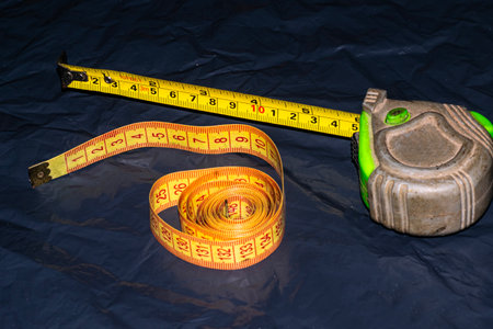Tape measuring on a black backgroundの写真素材