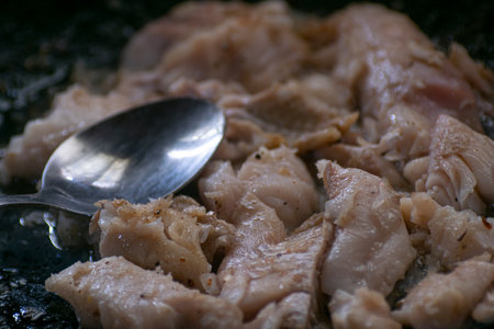 Cooked hake on a black cooking panの写真素材