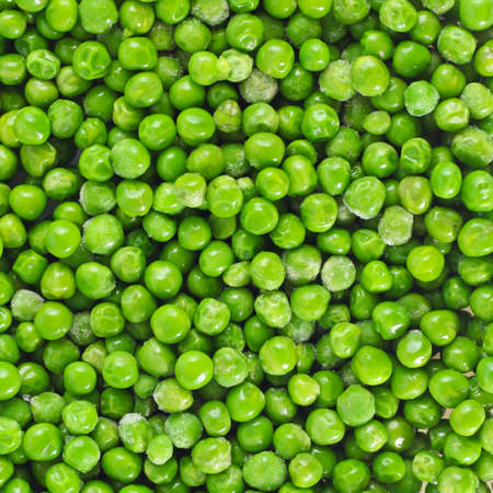 Shelled fresh ripe green peas backgroundの写真素材
