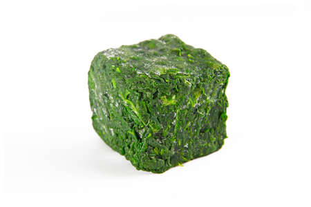 a block of frozen spinach isolated on a white backgroundの写真素材