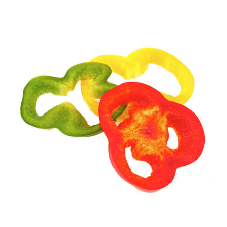 Red, green and yellow sliced pepper, isolated on whiteの写真素材