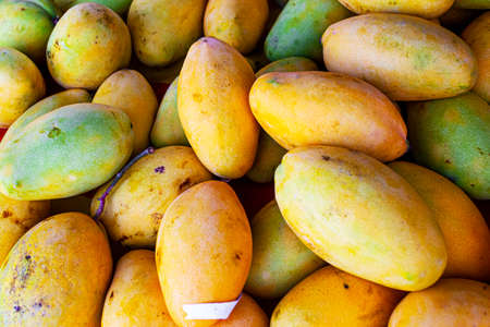 Sweet tasty mango in market - fruit background