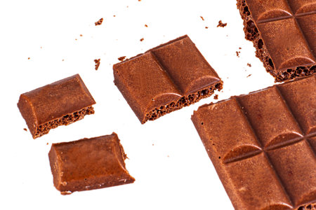 Porous milk black chocolate isolated on white background