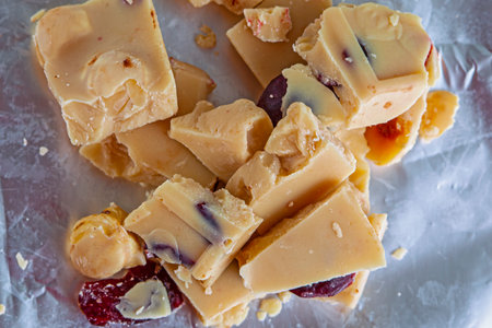 Sweet white chocolate with nuts, crashed on silver foilの写真素材