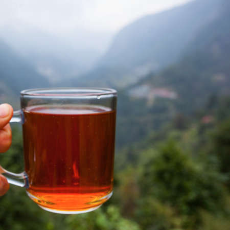 Black tea cup near teahouse, in Himalayas, Nepal, trekking