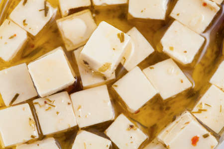 Feta cheese in oil with spicesの写真素材