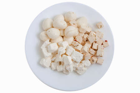 Assortment of cheese on the plate, isolated on whiteの写真素材