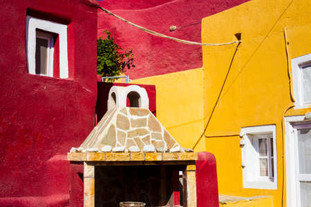 Red and yellow Streets and houses of Megalochori town, Santorini, Greeceの写真素材