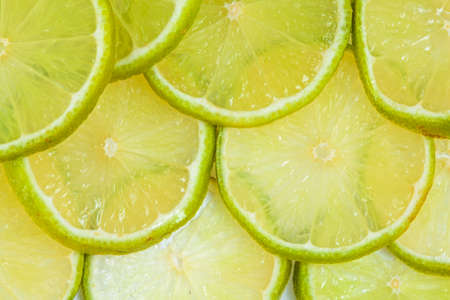 Fresh juicy sliced green lime - citrus backgroundの写真素材