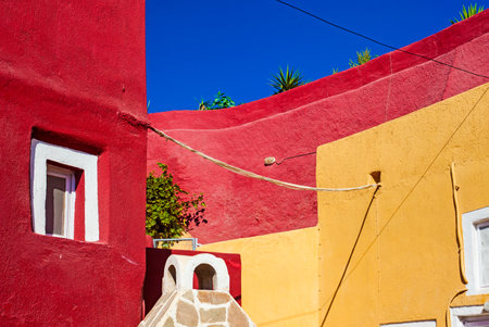 Red and yellow Streets and houses of Megalochori town, Santorini, Greeceの写真素材