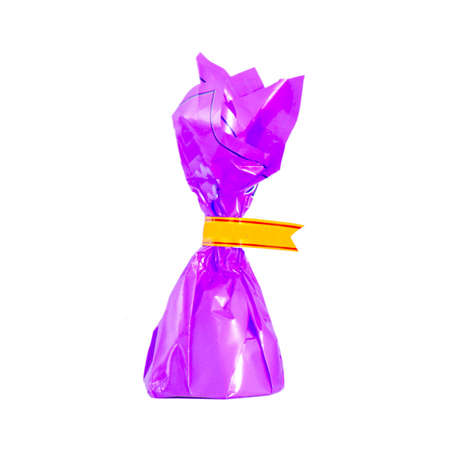 Candy in lilac paper isolated on whiteの写真素材