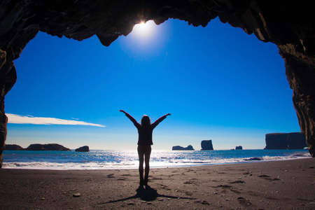 Silhouette of the woman on the beach in Iceland