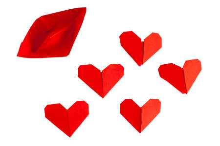Red origami boat and hearts isolated on whiteの写真素材