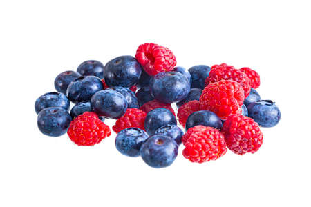 Fresh bright raspberries and blueberries heap isolatedの写真素材
