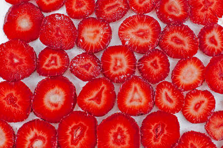 Bright fresh juicy sliced strawberry backgroundの写真素材