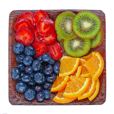 Fresh summer berries and fruits assortment on the wooden plateの写真素材