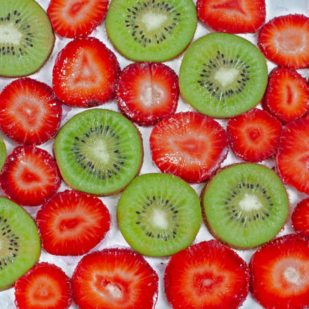 Fresh green sliced kiwi and strawberry background - healthy foodの写真素材