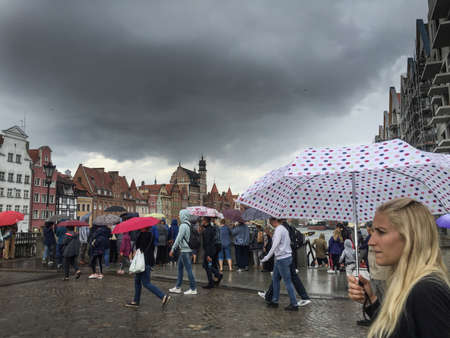 Gdansk, Poland- September 2, .2018: Tourists on the Long Lane of the old town in Gdansk, tower of...