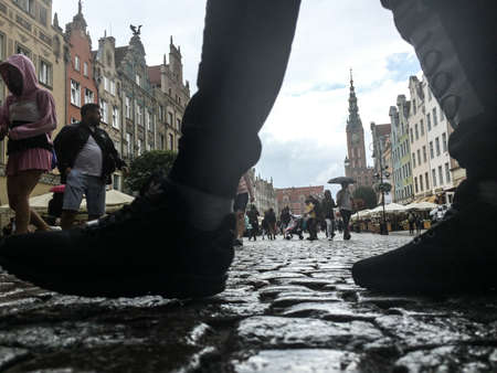 Gdansk, Poland- September 2, .2018: Tourists on the Long Lane of the old town in Gdansk, tower of...