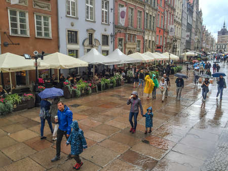 Gdansk, Poland- September 2, .2018: Tourists on the Long Lane of the old town in Gdansk, tower of...