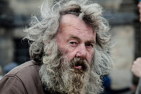 Amsterdam, The Netherlands - May 9, 2015: old poor man walking by the streets of Amsterdam on May 9, 2015 in Amsterdam, Hollandのeditorial素材