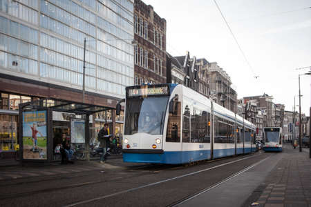 Amsterdam, Netherlands - May 13, 2015: The tram stop near Centraal station. Amsterdam Centraal station is the largest train station of Amsterdam and a major national rail hub with 260,000 passengersのeditorial素材