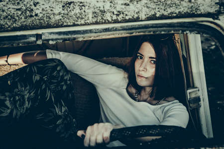 beautiful young girl poses near retro carの写真素材